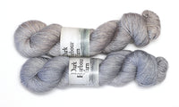 Skein of hand-dyed merino/silk yarn in light grey pink and light lavender