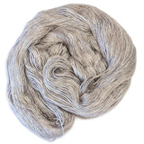 Skein of hand-dyed merino/silk yarn in light grey pink