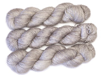 Skein of hand-dyed merino/silk yarn in light grey pink